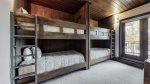 Second bedroom offers two bunks, balcony access, ski locker and en suite bathroom 